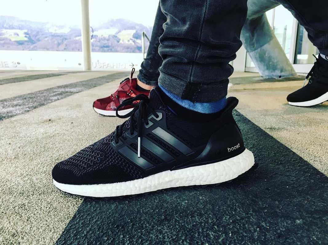 core black ultra boost on feet